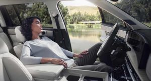 Hyundai Santa Fe 2025 - interiores amplios, mujer descansando en asiento frontal reclinado